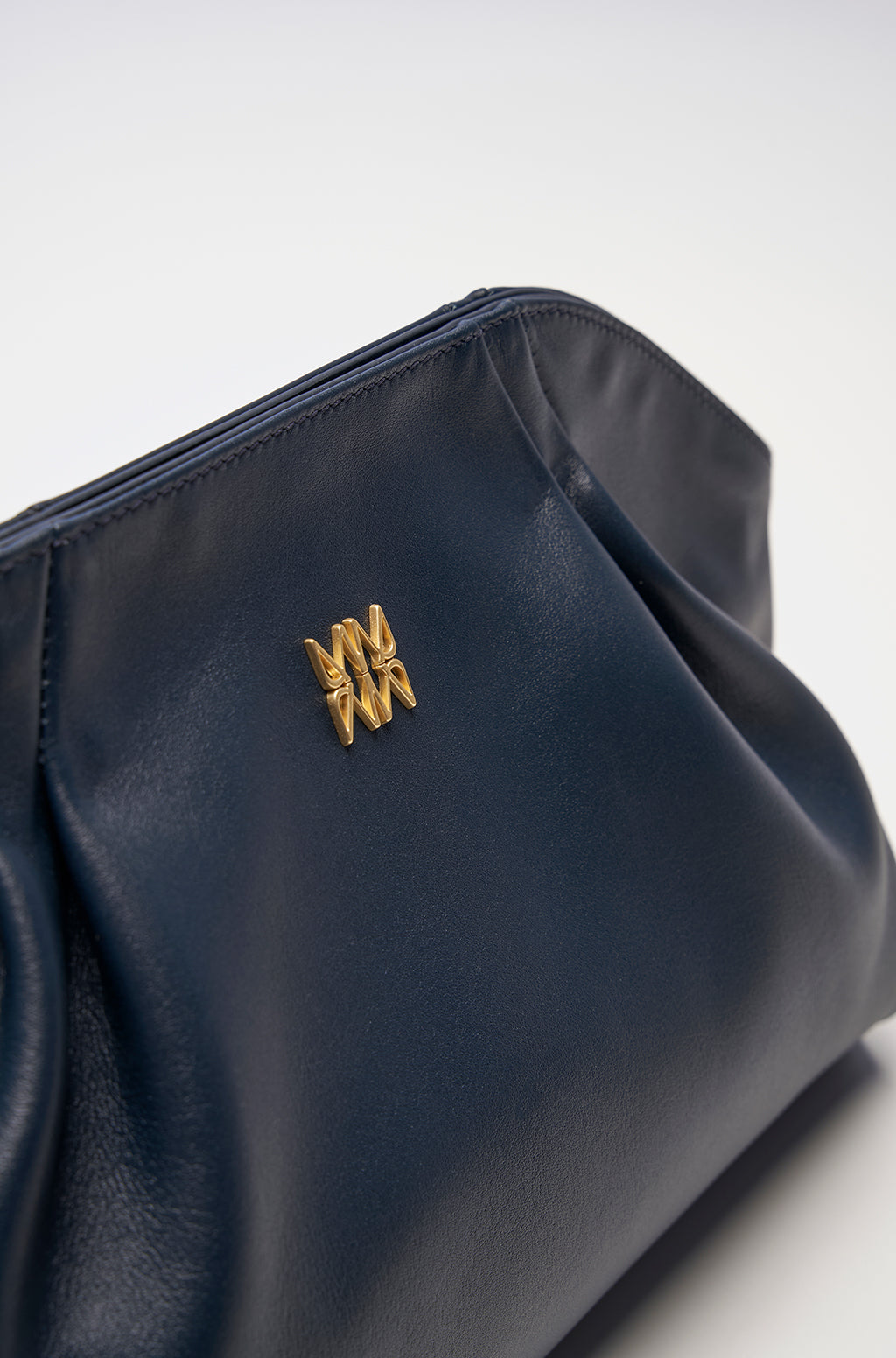 Leather Slouchy Clutch With Metallic Monogram